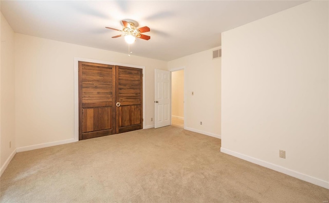 unfurnished bedroom with a ceiling fan, a closet, baseboards, and carpet flooring