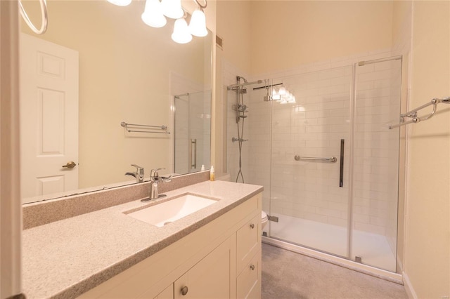 bathroom featuring visible vents, a shower stall, and vanity