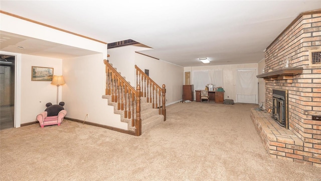 basement featuring a brick fireplace, baseboards, stairway, and carpet flooring