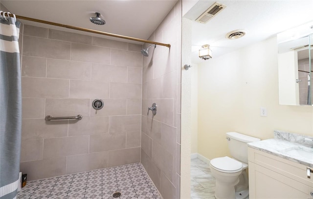 bathroom featuring visible vents, a tile shower, and toilet