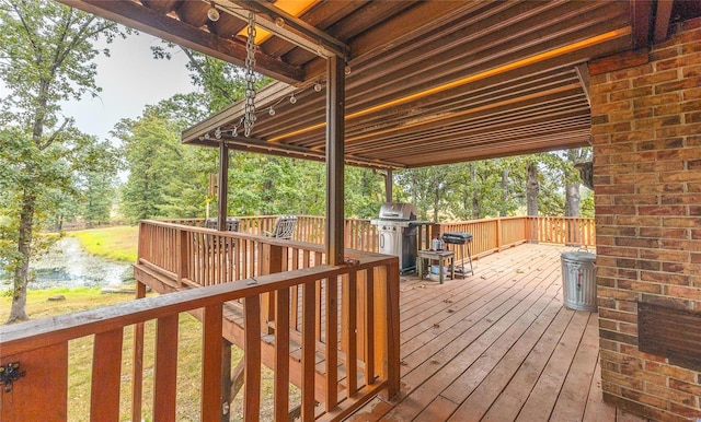 wooden terrace with a grill