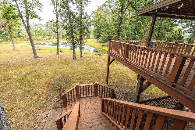 wooden deck featuring a water view and a yard