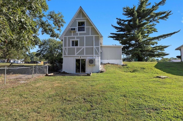 back of property with an outdoor structure and a yard