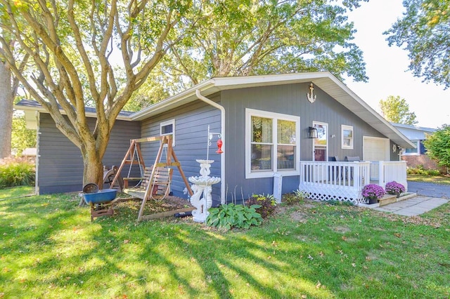 exterior space featuring a garage and a yard