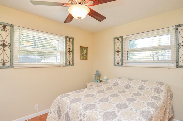 bedroom with ceiling fan and hardwood / wood-style flooring