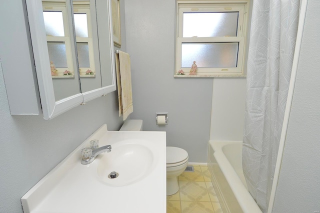 full bathroom featuring sink, toilet, tile patterned flooring, and shower / tub combo with curtain