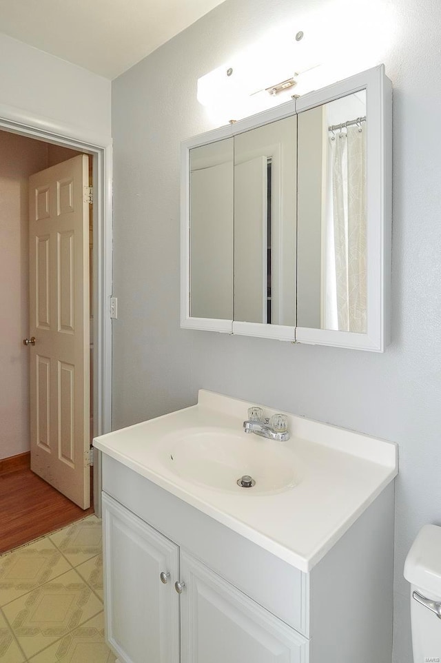 bathroom featuring toilet and vanity