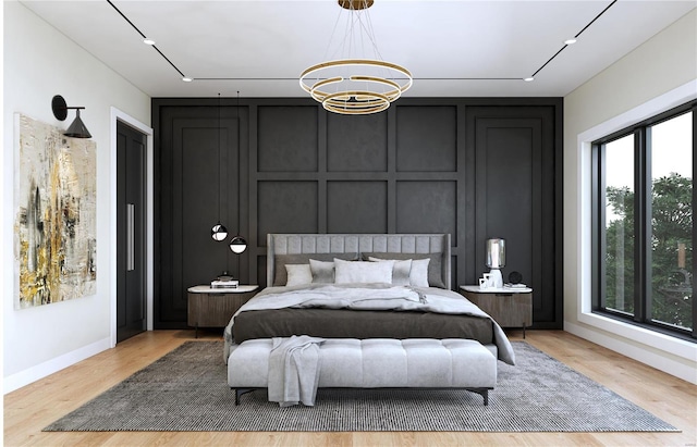 bedroom featuring a notable chandelier and light wood-type flooring