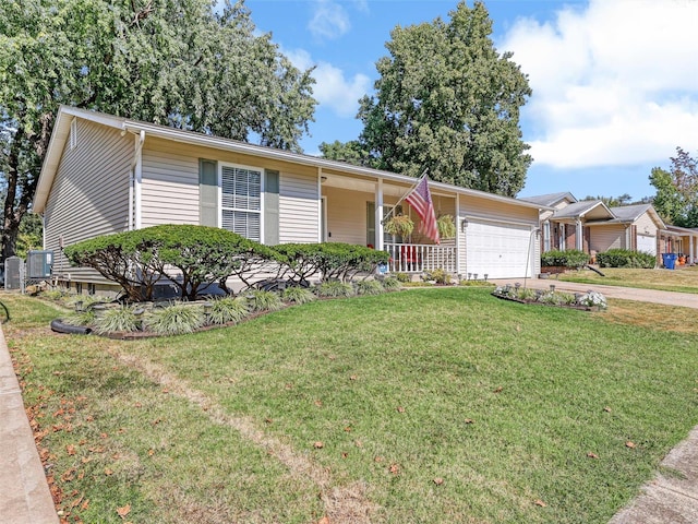 ranch-style home featuring cooling unit, a garage, a porch, and a front lawn