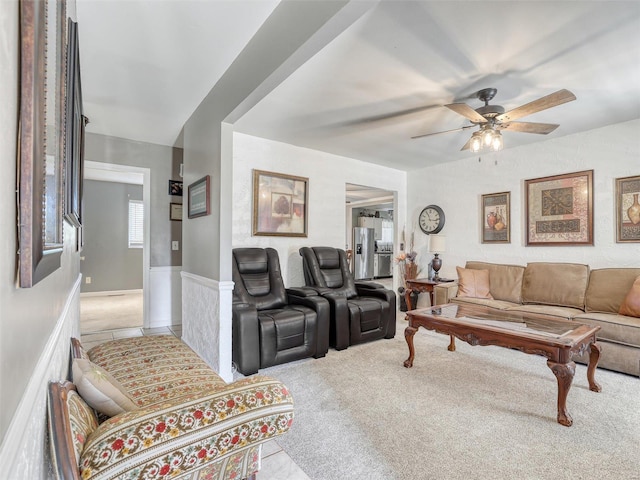 living room with ceiling fan and light colored carpet