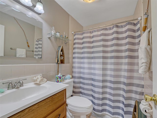 bathroom with tile walls, decorative backsplash, a shower with curtain, vanity, and toilet