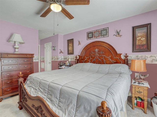 bedroom with ceiling fan, light carpet, and a closet