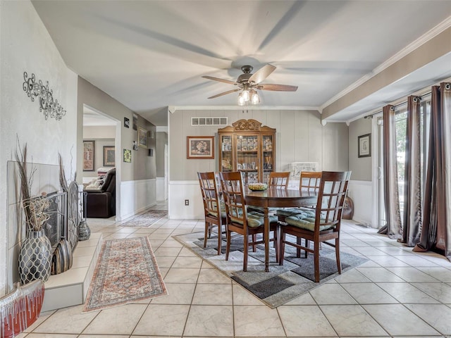 dining room with ornamental molding, ceiling fan, and light tile patterned flooring