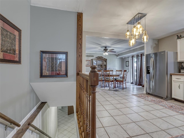 interior space with ceiling fan with notable chandelier