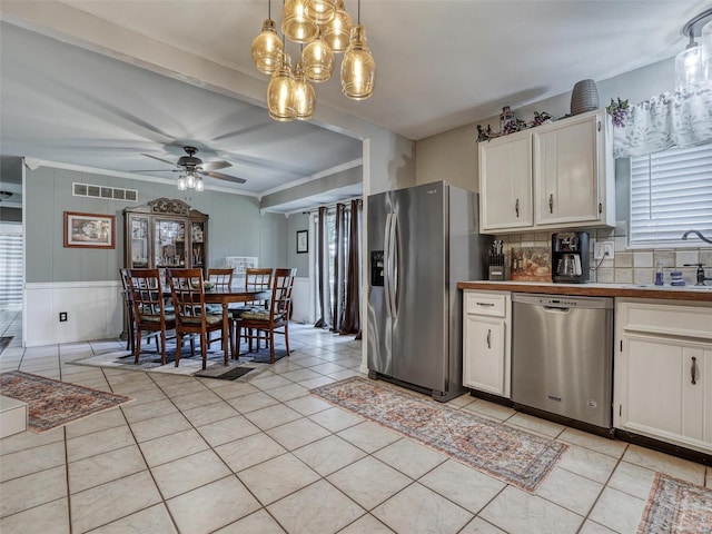 kitchen featuring pendant lighting, sink, white cabinetry, appliances with stainless steel finishes, and ceiling fan