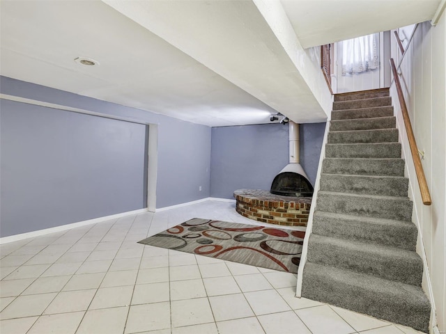 staircase featuring a wood stove and tile patterned flooring