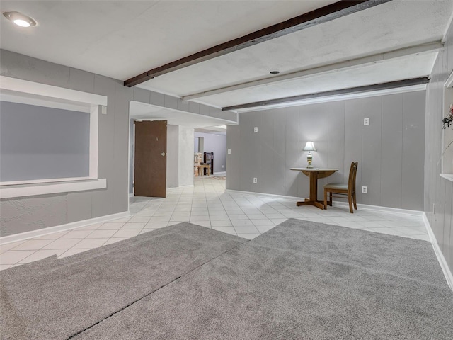 tiled spare room with beamed ceiling