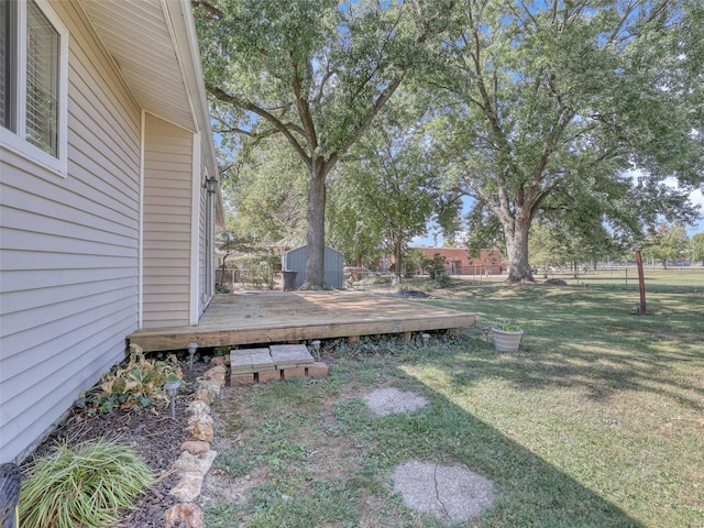 view of yard with a wooden deck and a shed