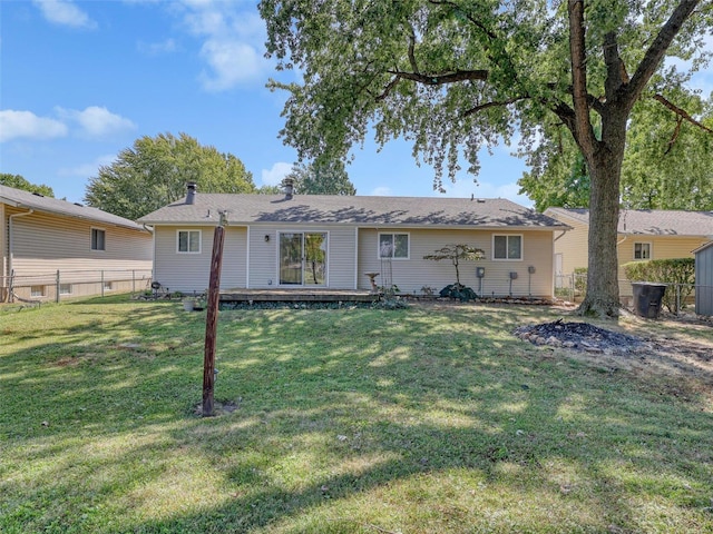 rear view of property with a lawn