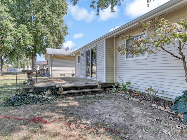 view of exterior entry with a wooden deck