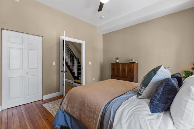 bedroom with a closet, ceiling fan, and dark hardwood / wood-style flooring