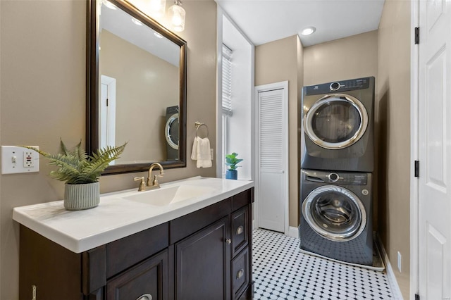 laundry room featuring sink and stacked washer / drying machine