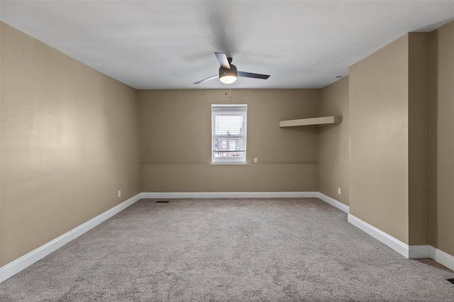 spare room featuring ceiling fan and carpet