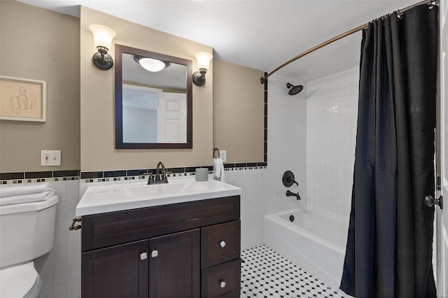 full bathroom with vanity, toilet, tile walls, and shower / bath combination with curtain