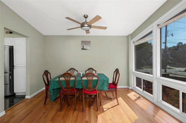 dining space featuring light wood-type flooring and ceiling fan