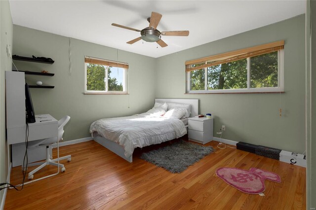 bedroom with light wood-type flooring and ceiling fan