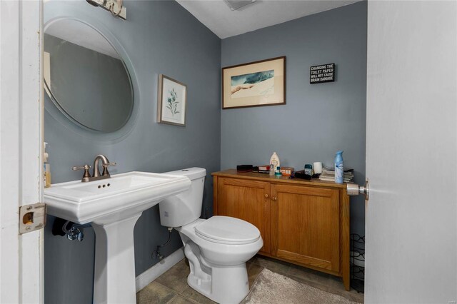 bathroom featuring tile patterned flooring and toilet