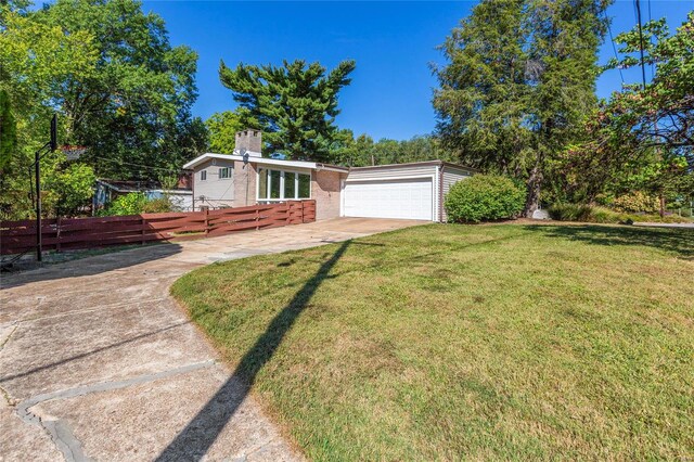 single story home with a garage and a front yard