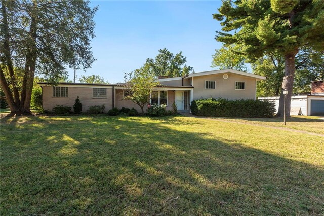 view of front of property with a front yard and a garage