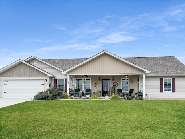 view of front facade featuring a garage, a front yard, and covered porch