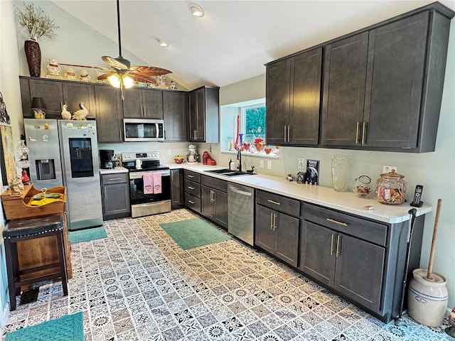 kitchen featuring stainless steel appliances, lofted ceiling, ceiling fan, dark brown cabinetry, and sink