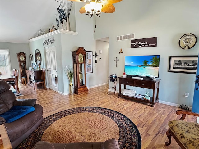 living room featuring vaulted ceiling, ceiling fan, and hardwood / wood-style flooring