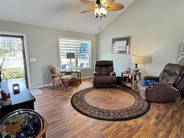 living room featuring ceiling fan, hardwood / wood-style flooring, and high vaulted ceiling