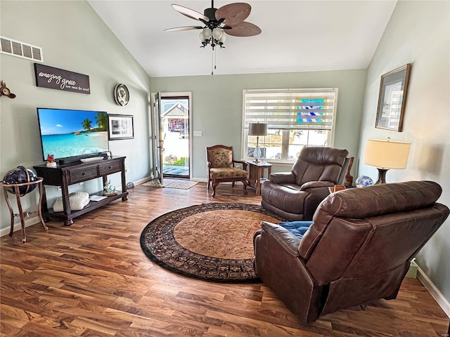 living room with lofted ceiling, ceiling fan, and dark hardwood / wood-style floors