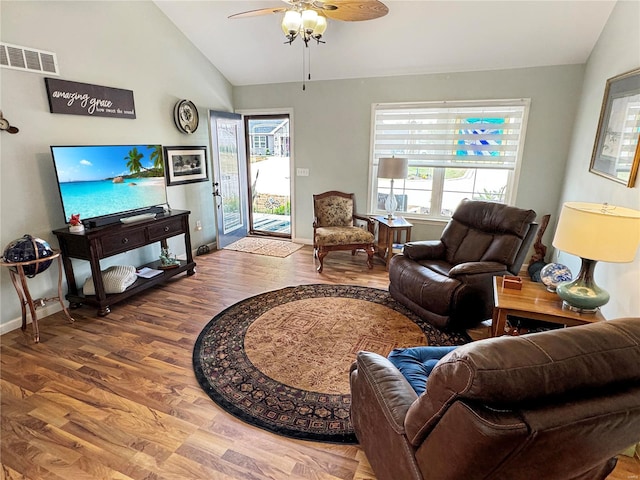 living room featuring lofted ceiling, ceiling fan, hardwood / wood-style flooring, and plenty of natural light