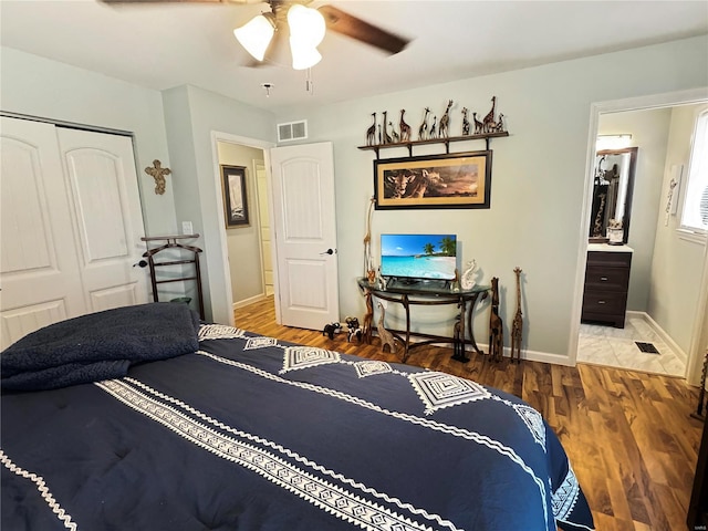 bedroom with ceiling fan, a closet, and hardwood / wood-style floors