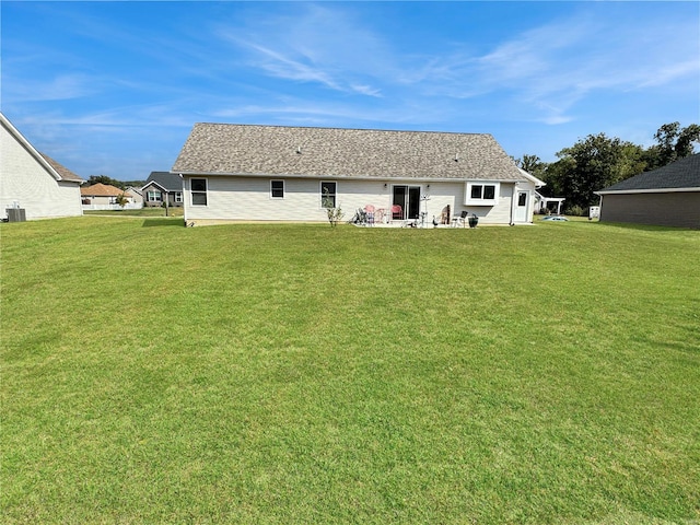 rear view of house featuring a yard