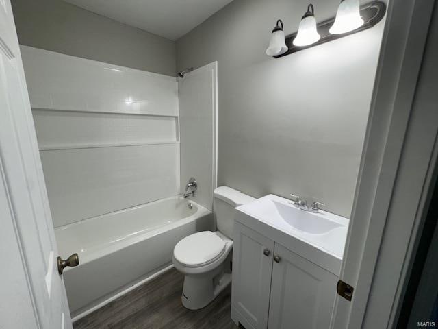 full bathroom with shower / washtub combination, vanity, toilet, and hardwood / wood-style flooring