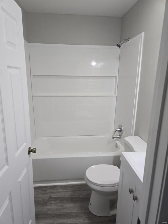 full bathroom featuring tub / shower combination, vanity, toilet, and hardwood / wood-style floors