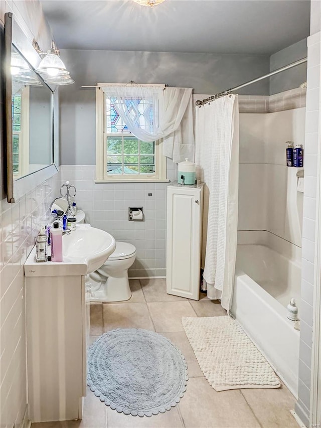 full bathroom featuring vanity, tile patterned flooring, tile walls, toilet, and shower / bathtub combination with curtain