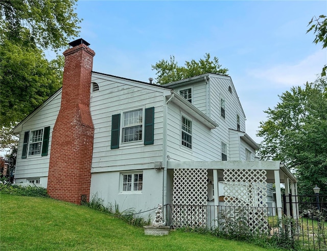 view of side of home with a yard