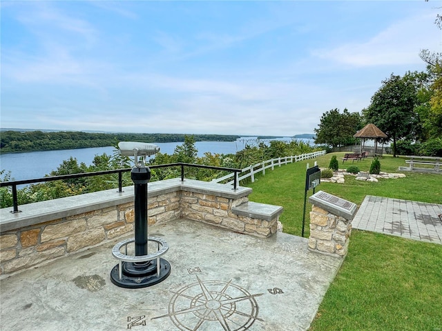 view of patio / terrace featuring a water view, a fire pit, and a gazebo