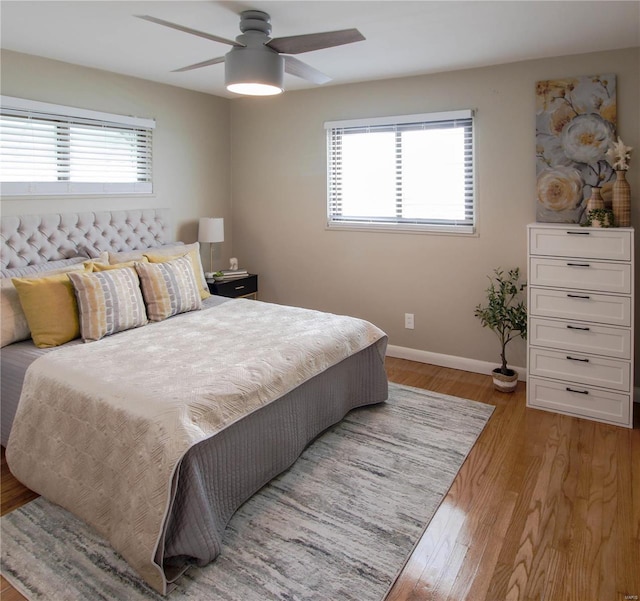 bedroom with light hardwood / wood-style floors and ceiling fan