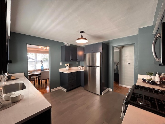 kitchen with stainless steel appliances, dark wood-type flooring, and sink