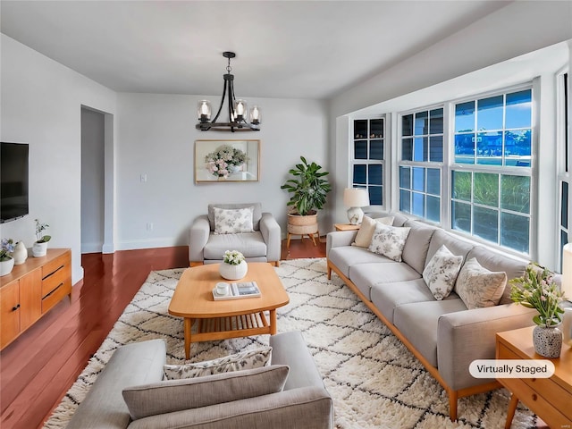 living room with hardwood / wood-style floors and an inviting chandelier