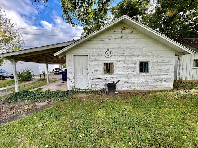 view of side of home with a lawn